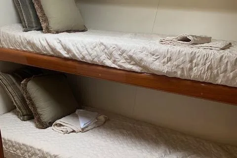 Slide: The Image of Bunk beds in a 2002 Viking 55 Convertible yacht cabin with cozy bedding. - 27