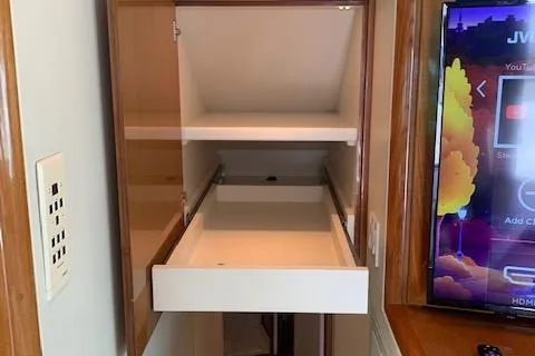 Slide: The Image of Open cabinet with pull-out drawer in 2002 Viking 55 Convertible yacht interior. - 28