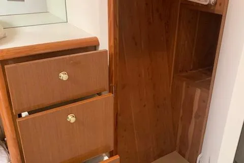 Slide: The Image of Wooden cabinetry and closet inside a 2002 Viking 55 Convertible yacht. - 30