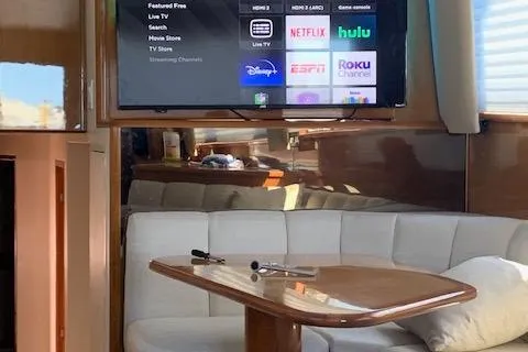 Slide: The Image of Interior of 2002 Viking 55 Convertible yacht with TV and cozy seating area. - 32