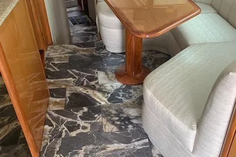 Slide: The Image of Interior of 2002 Viking 55 Convertible yacht with marble flooring and wooden table. - 34