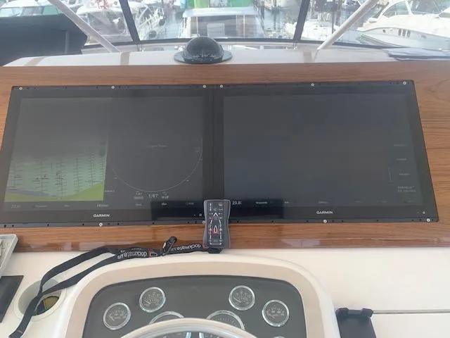 Slide: The Image of Control panel of a 2002 Viking 55 Convertible yacht with dual Garmin displays. - 4