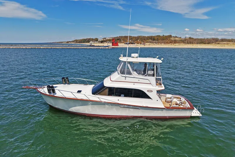 The Image of 1988 Ocean Yachts 48 Super Sport cruising on calm waters under a clear sky. - 0