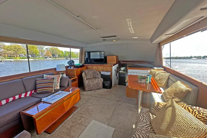 Slide: The Image of Interior of 1988 Ocean Yachts 48 Super Sport with cozy seating and scenic water views. - 10