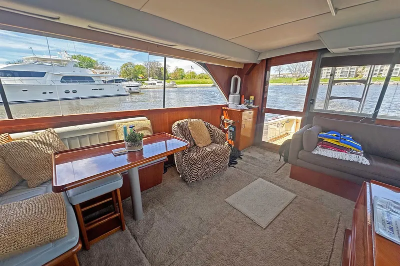 Slide: The Image of Interior of 1988 Ocean Yachts 48 Super Sport with cozy seating and waterfront view. - 11