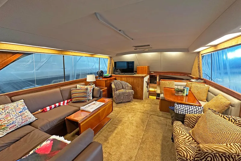 Slide: The Image of Luxurious interior of 1988 Ocean Yachts 48 Super Sport with cozy seating and elegant decor. - 12