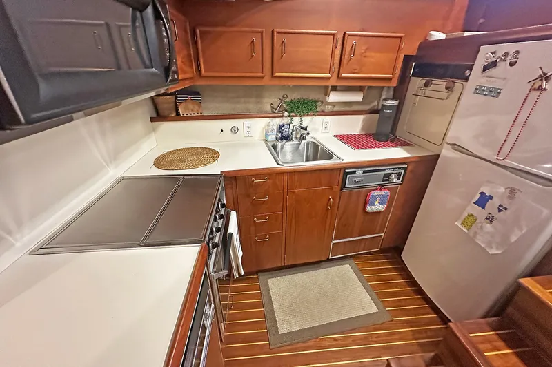 Slide: The Image of Galley kitchen in 1988 Ocean Yachts 48 Super Sport with wood cabinetry and modern appliances. - 18