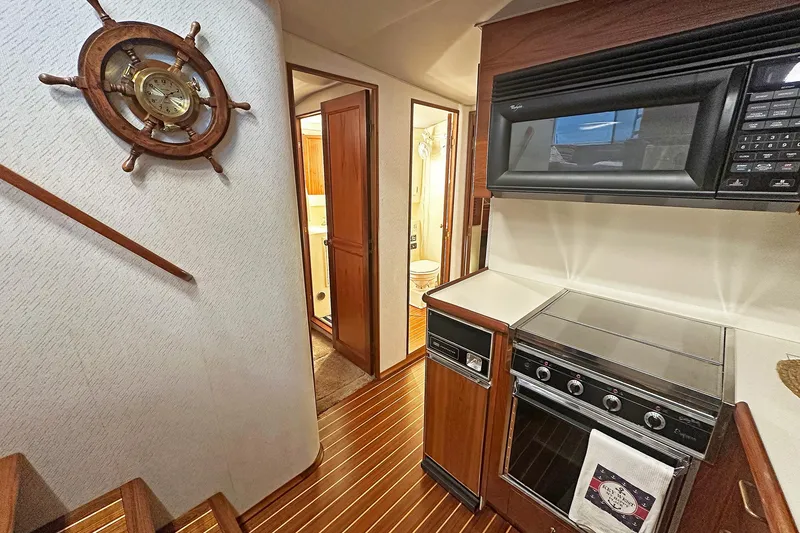Slide: The Image of 1988 Ocean Yachts 48 Super Sport interior with kitchen and nautical decor. - 19