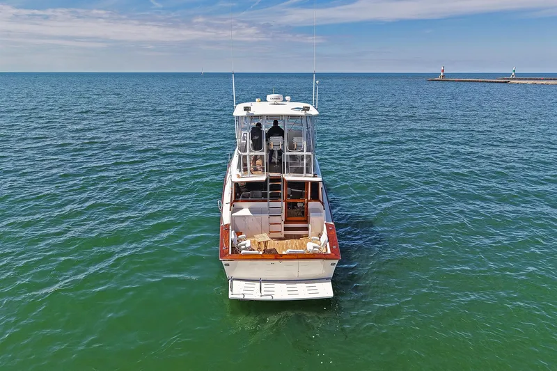 Slide: The Image of 1988 Ocean Yachts 48 Super Sport cruising on open water under a clear sky. - 2