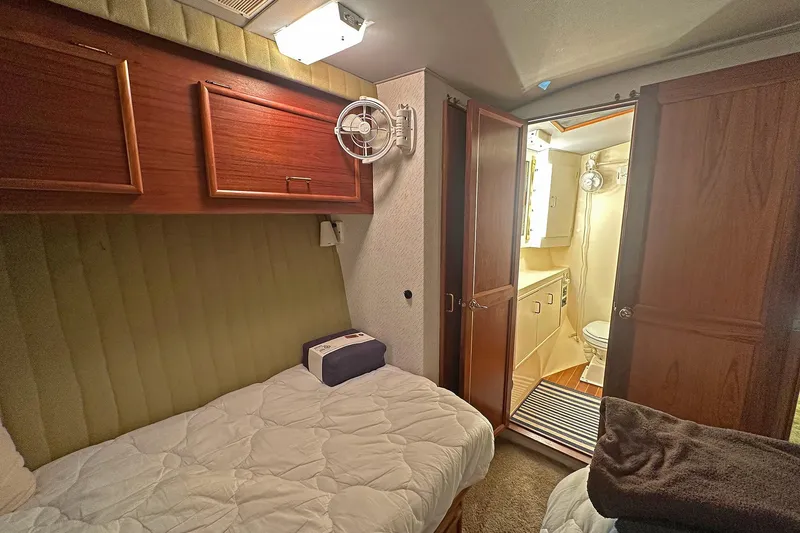 Slide: The Image of Cozy cabin interior of 1988 Ocean Yachts 48 Super Sport with bed and bathroom. - 23