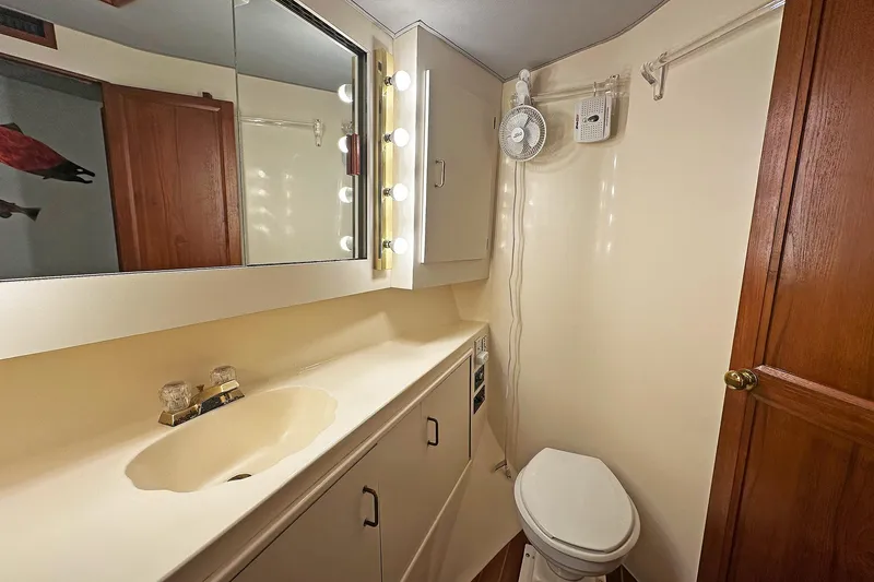 Slide: The Image of Bathroom interior of 1988 Ocean Yachts 48 Super Sport with vanity and toilet. - 25