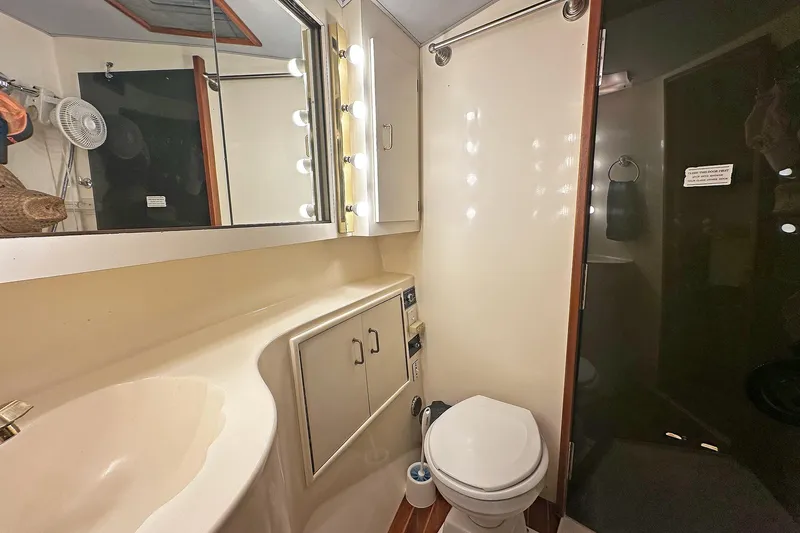 Slide: The Image of Bathroom interior of 1988 Ocean Yachts 48 Super Sport, featuring sink, toilet, and shower. - 27
