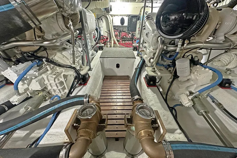 Slide: The Image of Engine room of 1988 Ocean Yachts 48 Super Sport with dual engines and mechanical components. - 29