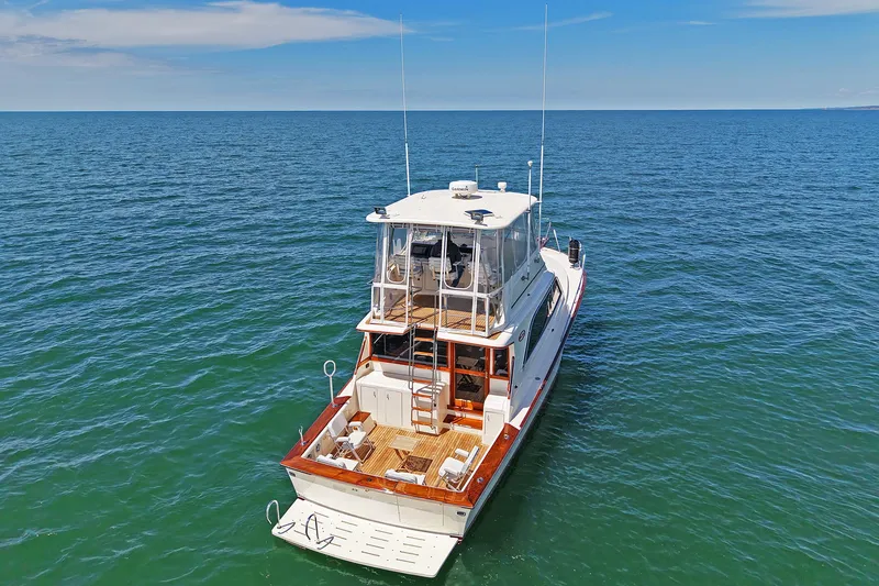 Slide: The Image of 1988 Ocean Yachts 48 Super Sport cruising on open sea under clear blue sky. - 3
