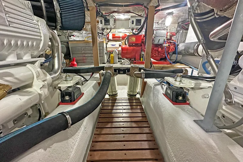 Slide: The Image of Engine room of 1988 Ocean Yachts 48 Super Sport, showcasing mechanical components and equipment. - 30
