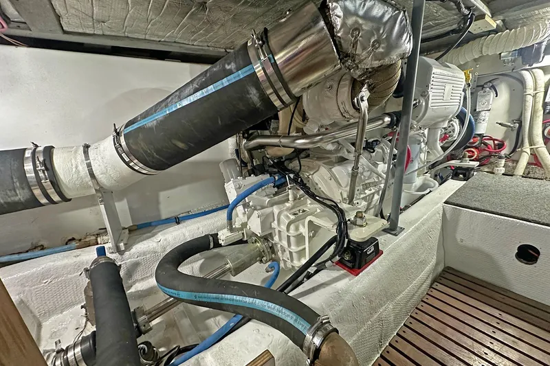 Slide: The Image of Engine room of 1988 Ocean Yachts 48 Super Sport, showcasing detailed mechanical components. - 32