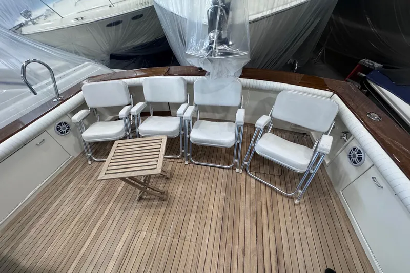 Slide: The Image of 1988 Ocean Yachts 48 Super Sport deck with chairs and table, showcasing luxury seating. - 35