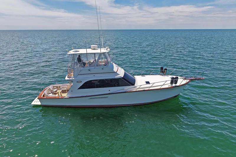 Slide: The Image of 1988 Ocean Yachts 48 Super Sport cruising on open sea under clear skies. - 4