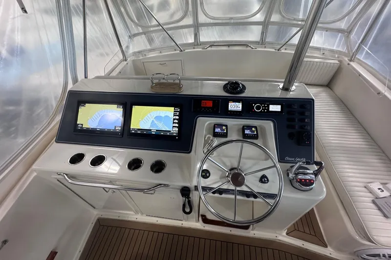 Slide: The Image of Helm of 1988 Ocean Yachts 48 Super Sport with dual navigation screens and steering wheel. - 40