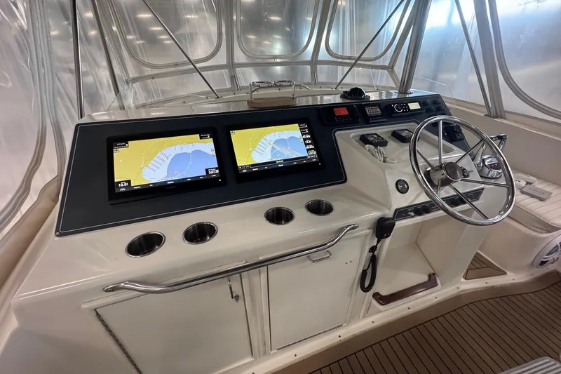 Slide: The Image of 1988 Ocean Yachts 48 Super Sport helm with dual navigation screens and steering wheel. - 41