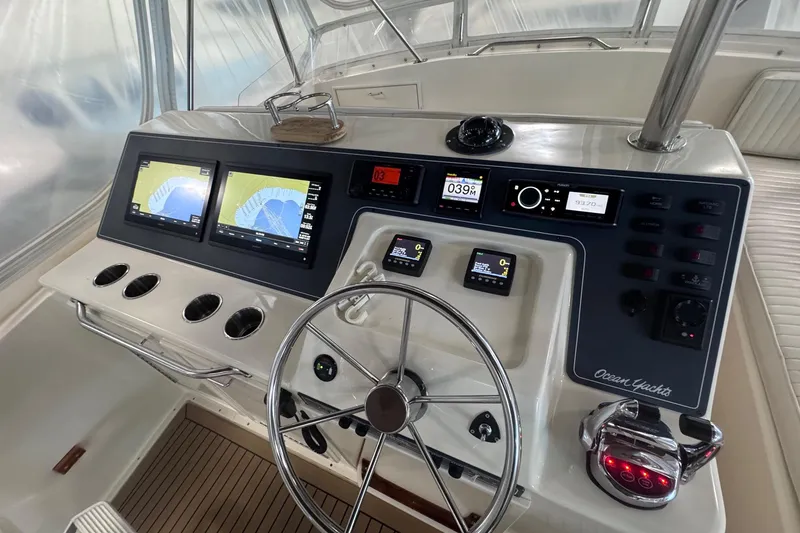 Slide: The Image of 1988 Ocean Yachts 48 Super Sport helm with advanced navigation displays and controls. - 42