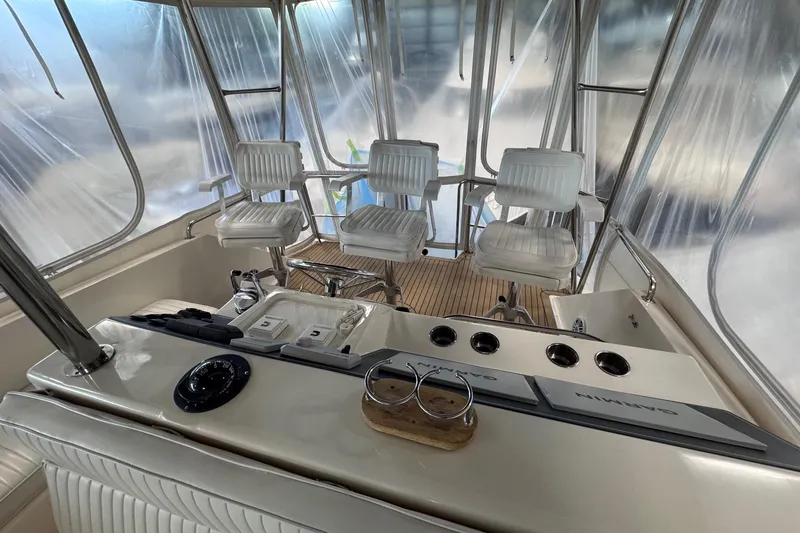 Slide: The Image of Interior view of 1988 Ocean Yachts 48 Super Sport cockpit with white seating and controls. - 44
