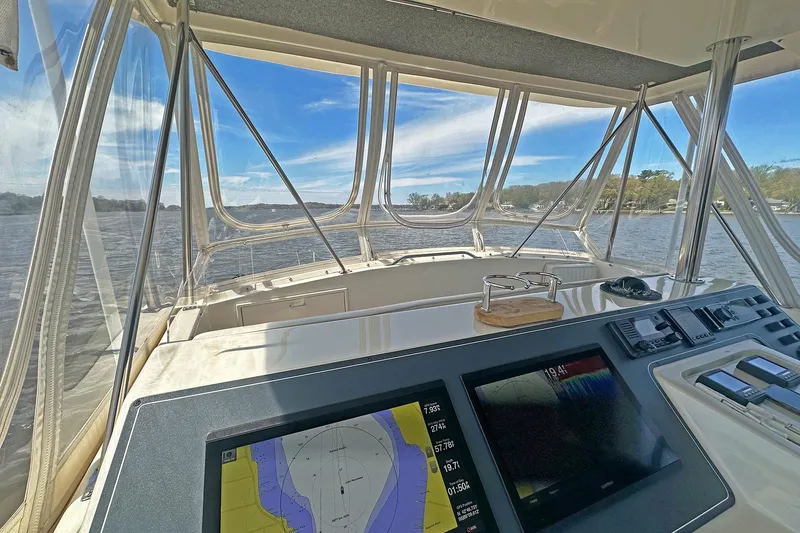 Slide: The Image of Cockpit view of 1988 Ocean Yachts 48 Super Sport with navigation screens and scenic waterway. - 6