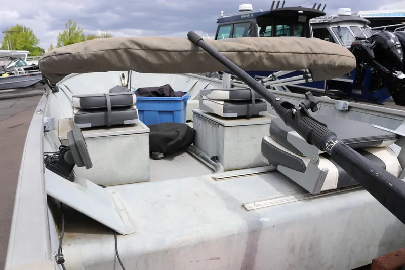 Slide: The Image of 2004 Smoker Craft Alaskan 15 boat interior with seating and storage compartments. - 4