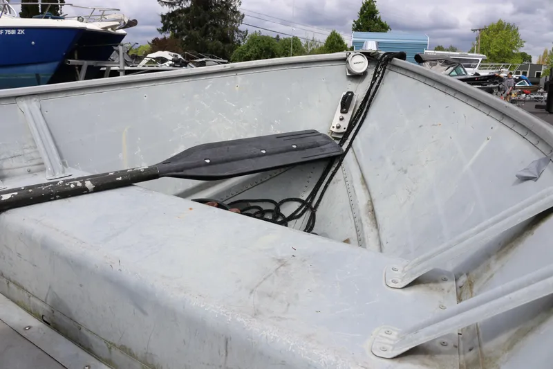 Slide: The Image of 2004 Smoker Craft Alaskan 15 boat interior with oar and ropes. - 5
