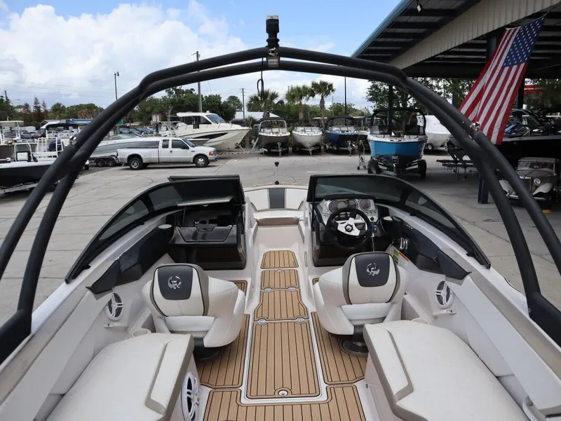 Slide: The Image of Interior view of a 2014 Scarab 215 boat at the marina. - 10