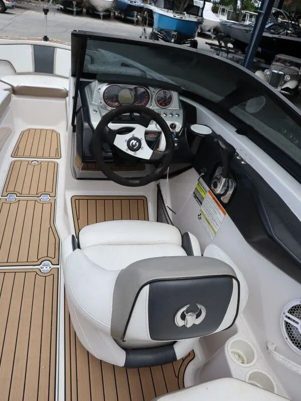 Slide: The Image of Interior of a 2014 Scarab 215 boat with steering console. - 11