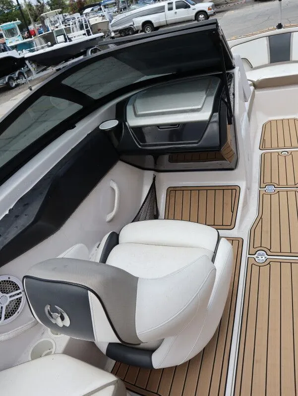 Slide: The Image of Interior of a 2014 Scarab 215 boat with seating and wood accents. - 13