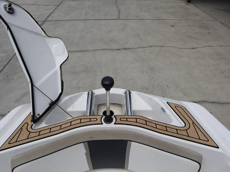 Slide: The Image of 2014 Scarab 215 boat with open storage hatch. - 17