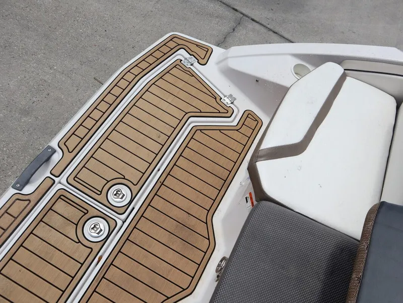 Slide: The Image of 2014 Scarab 215 boat with wood-pattern deck and seating area. - 23
