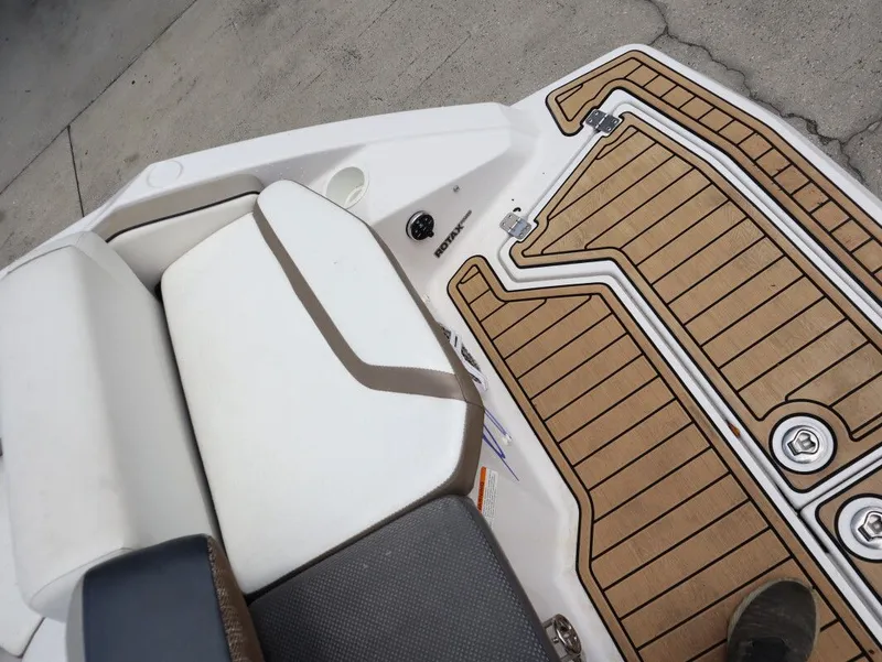 Slide: The Image of 2014 Scarab 215 boat with cushioned seat and wooden deck. - 24