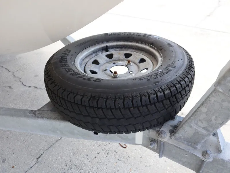 Slide: The Image of Spare tire on a 2014 Scarab 215 boat trailer. - 25