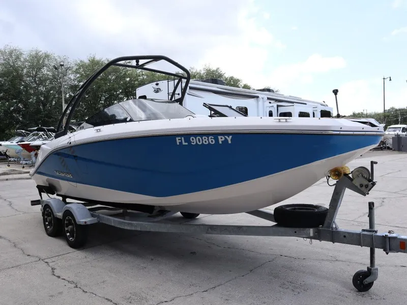 Slide: The Image of 2014 Scarab 215 boat on trailer, blue and white design. - 4