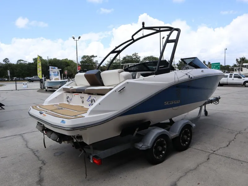 Slide: The Image of 2014 Scarab 215 boat parked on trailer outdoors. - 6