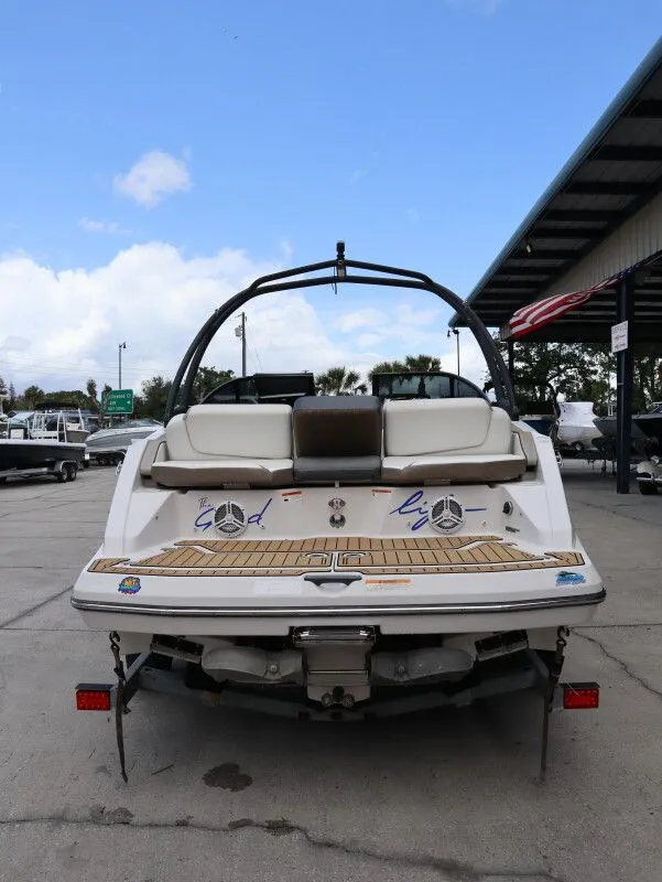 Slide: The Image of Rear view of a 2014 Scarab 215 boat on a parking lot. - 7