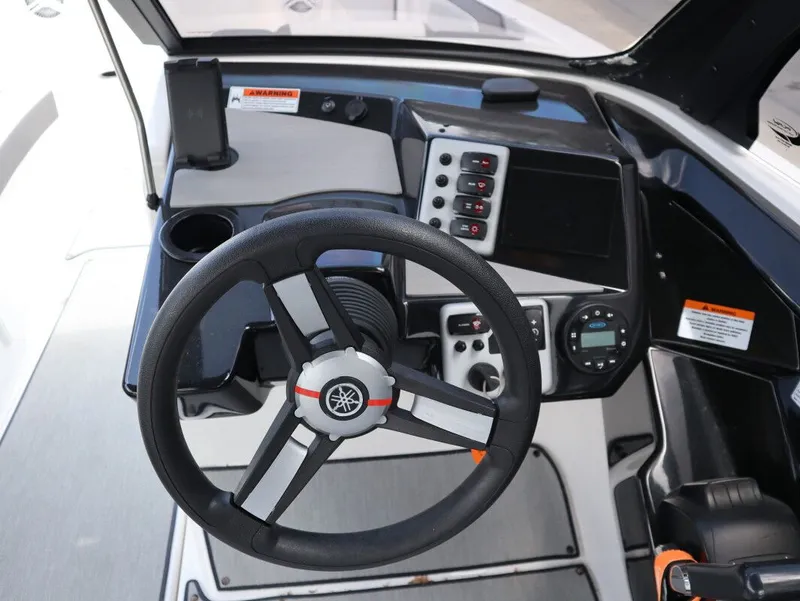 Slide: The Image of Yamaha Boats AR220 2023 helm with steering wheel and controls. - 18