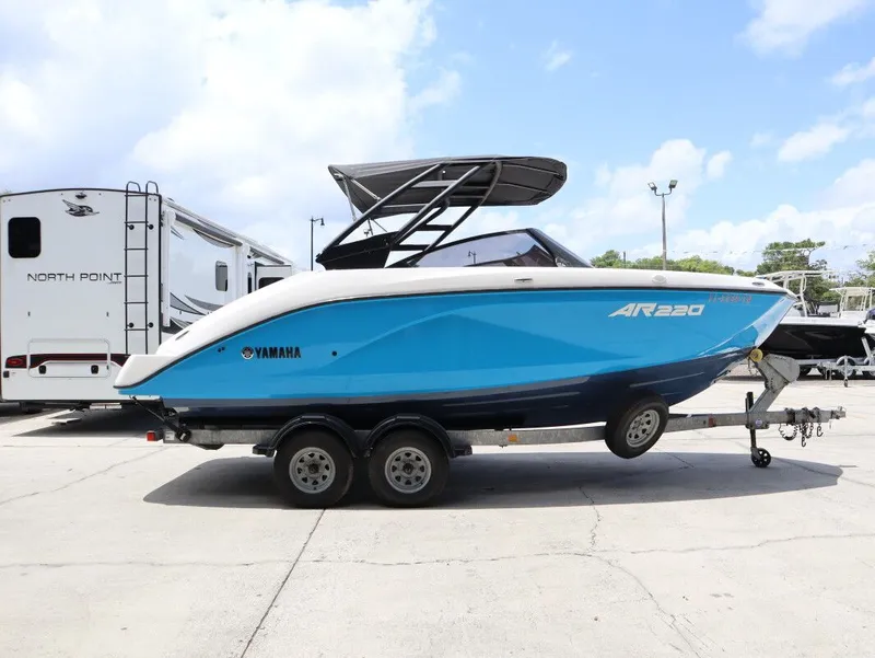 Slide: The Image of 2023 Yamaha AR220 boat on trailer, blue and white. - 5
