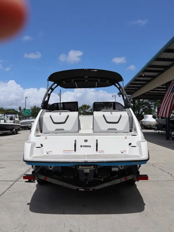Slide: The Image of Rear view of a 2023 Yamaha AR220 boat outdoors. - 7