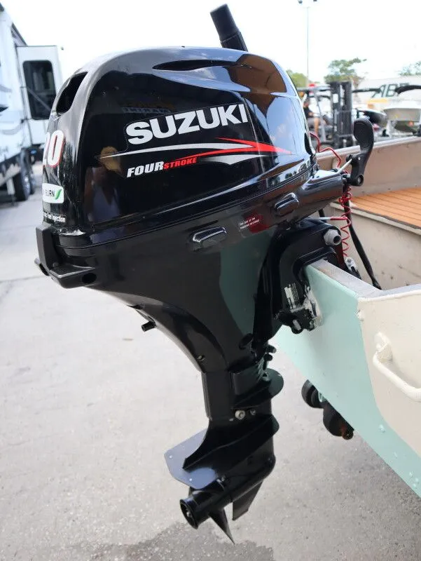 Slide: The Image of Suzuki outboard motor on a 1953 TDCM 16' Utility Fish Boat. - 10