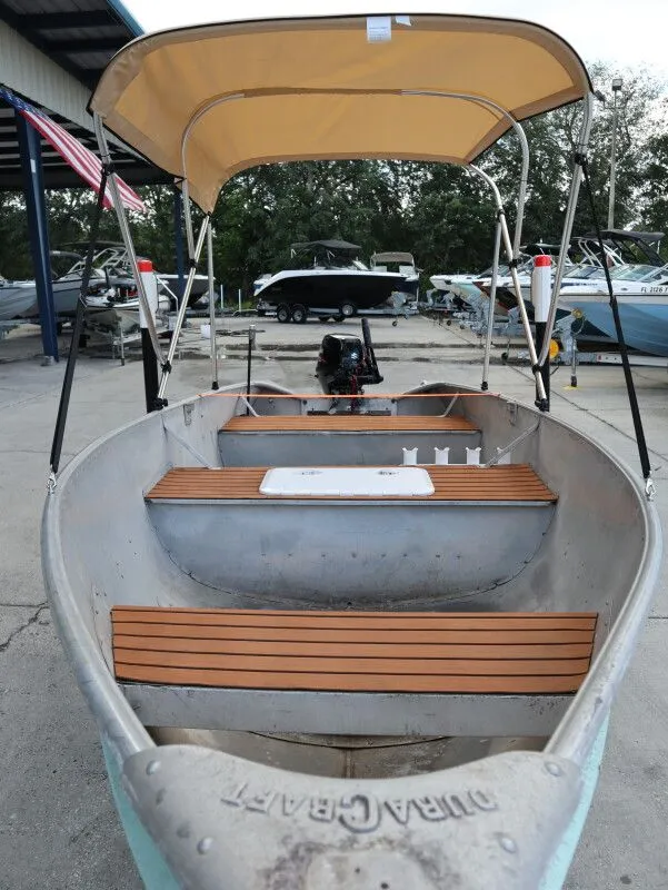 Slide: The Image of 1953 TDCM 16' Utility Fish Boat with canopy at dock. - 12