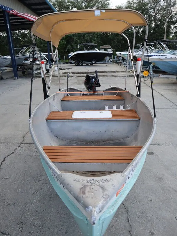 Slide: The Image of 1953 TDCM 16' Utility Fish Boat with canopy at dock. - 13