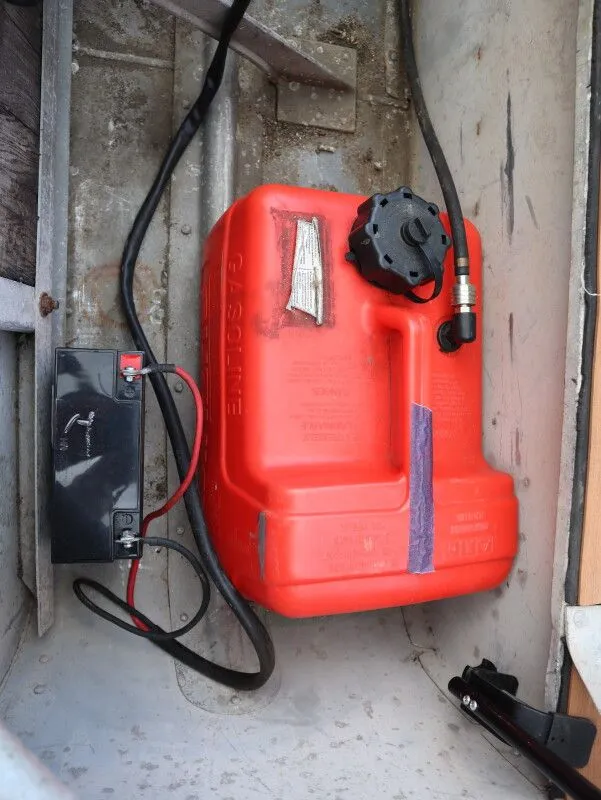 Slide: The Image of Red gas can and battery in a 1953 TDCM Utility Fish Boat. - 14