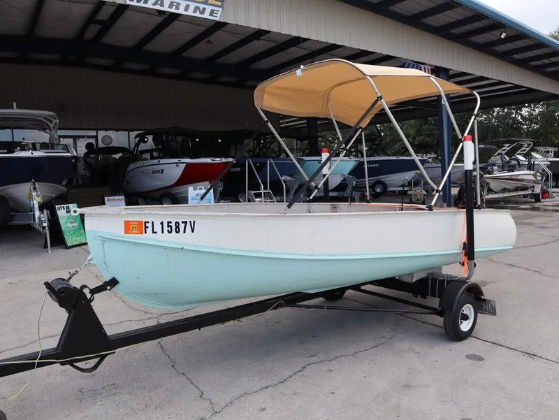 Slide: The Image of 1953 TDCM 16' Utility Fish Boat on trailer outdoors. - 3