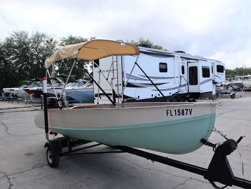 Slide: The Image of 1953 TDCM 16' Utility Fish Boat on trailer, with canopy. - 5