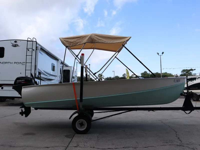 Slide: The Image of 1953 TDCM 16' Utility Fish Boat with Suzuki motor, on trailer. - 6