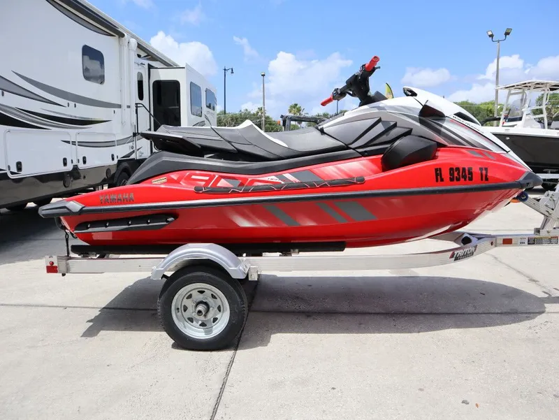 Slide: The Image of 2025 Yamaha GP 1900 HO jet ski on trailer, red and black, side view. - 6